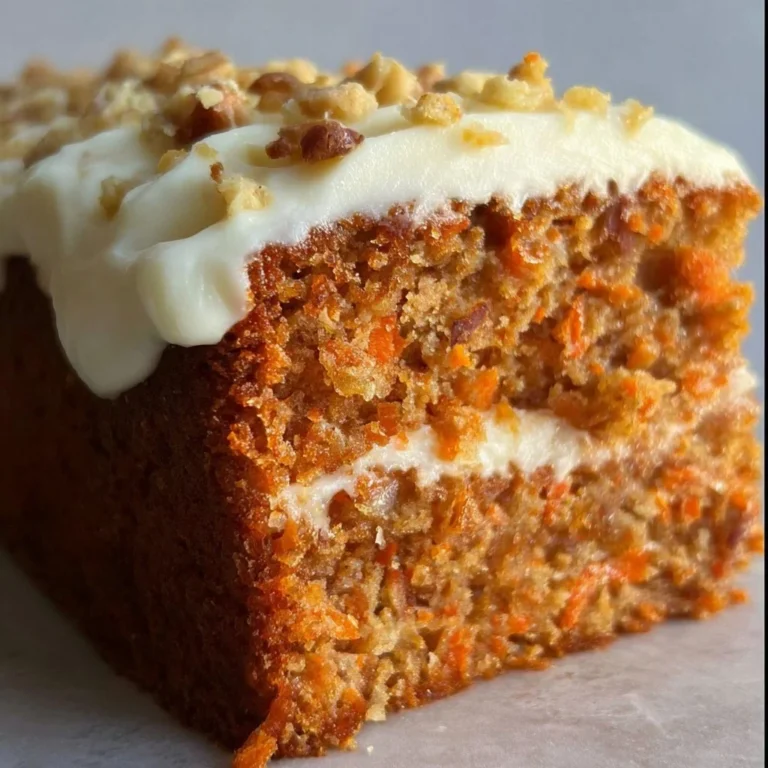 Delicious homemade carrot cake with cream cheese frosting and garnished with walnuts