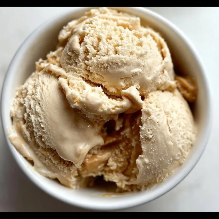 Delicious Peanut Butter Cottage Cheese Ice Cream in a bowl with a scoop on top.