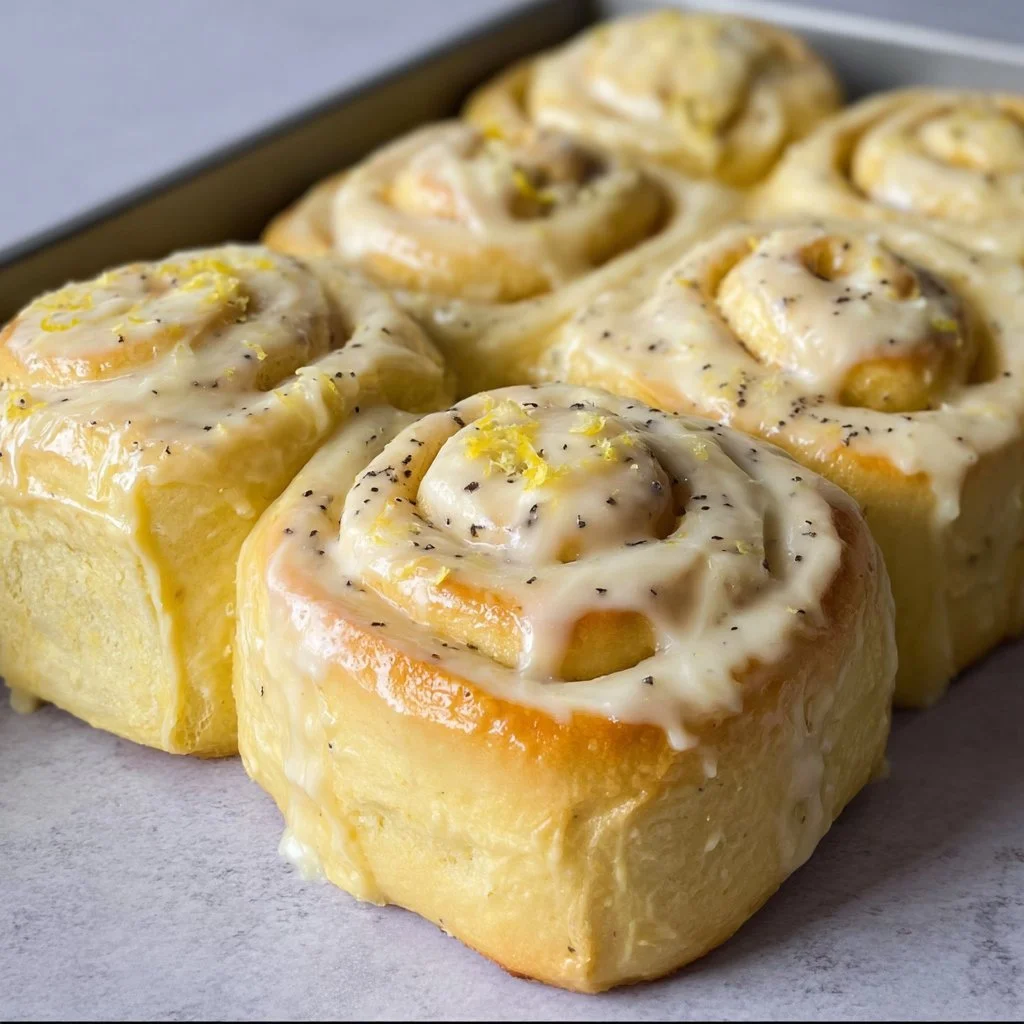 Freshly baked lemon rolls topped with a glaze.